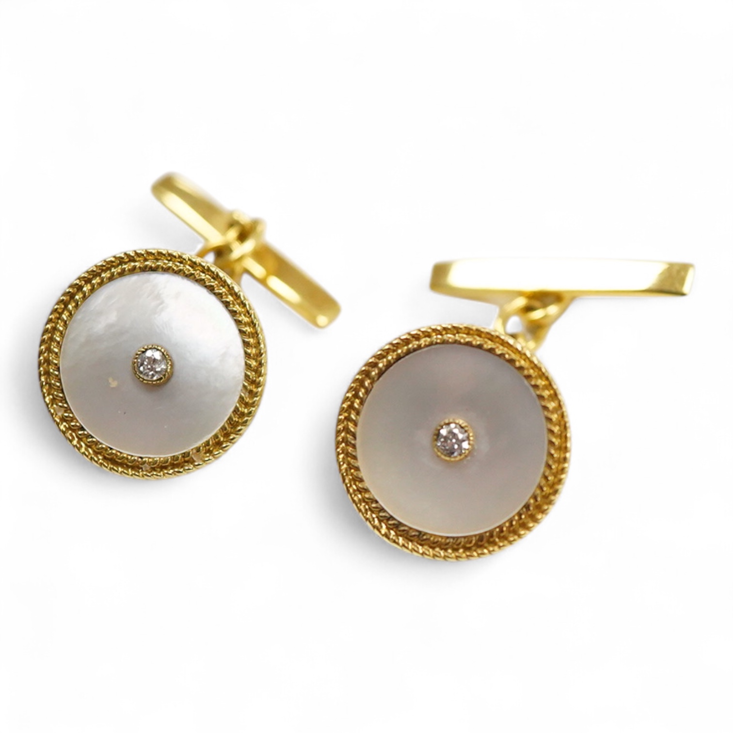 A pair of yellow metal (stamped 18) mounted, mother of pearl and diamond set disc cufflinks, diameter 12mm, gross weight 5.2 grams.